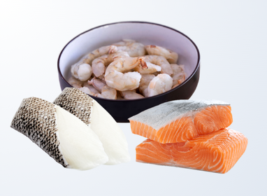 Bowl of shrimp with portions of white fish and salmon