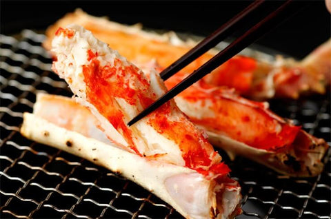 king crab leg meat in chopsticks
